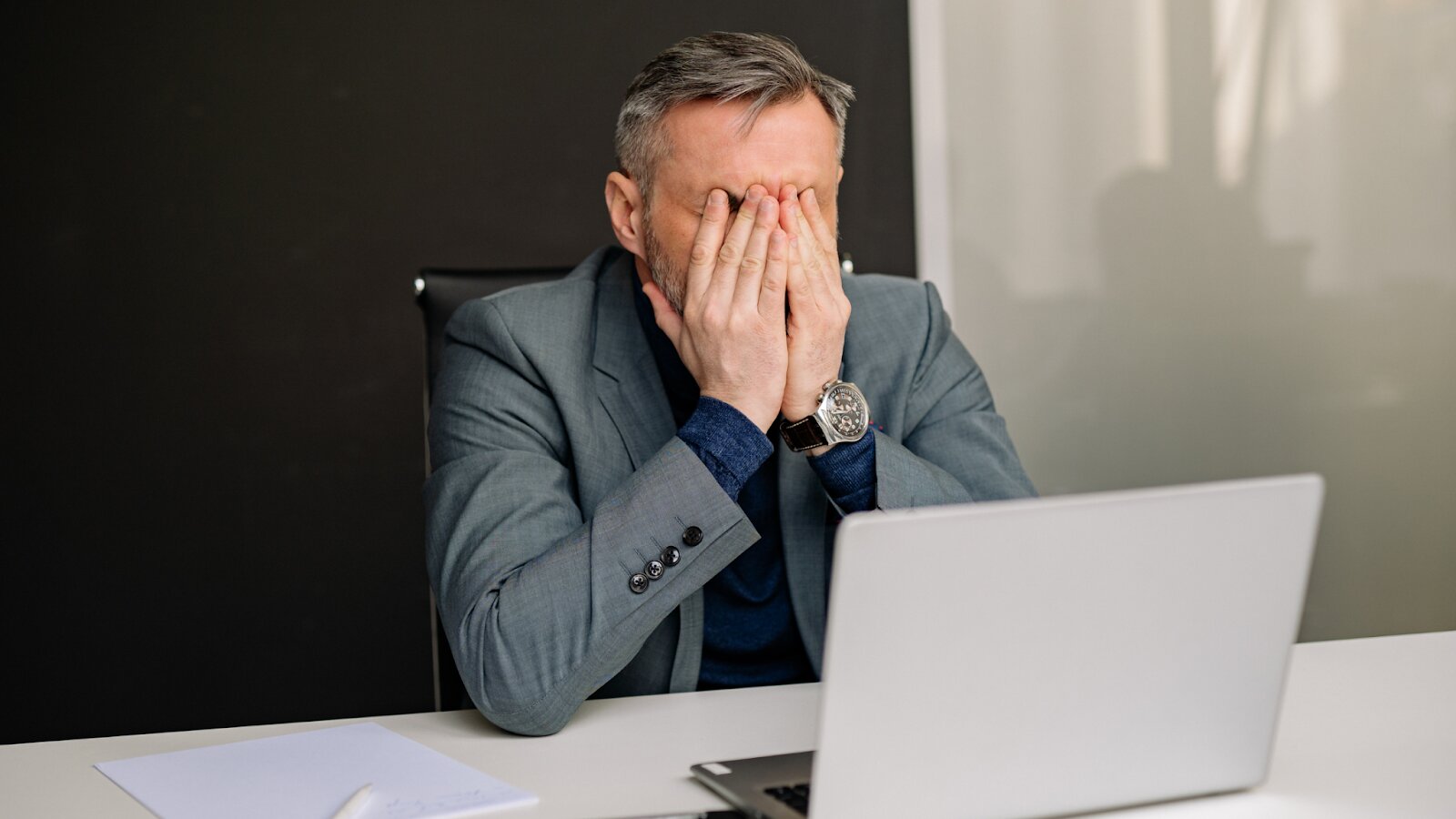 Frustrated executive at laptop highlighting the need for virtual CIO services