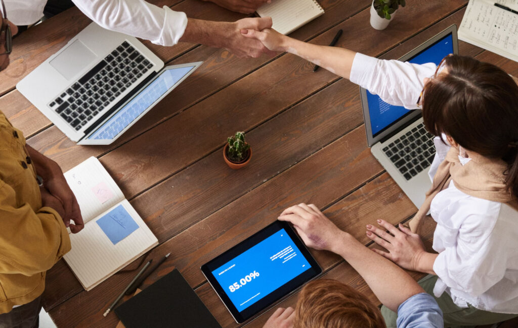Handshake across a meeting table.